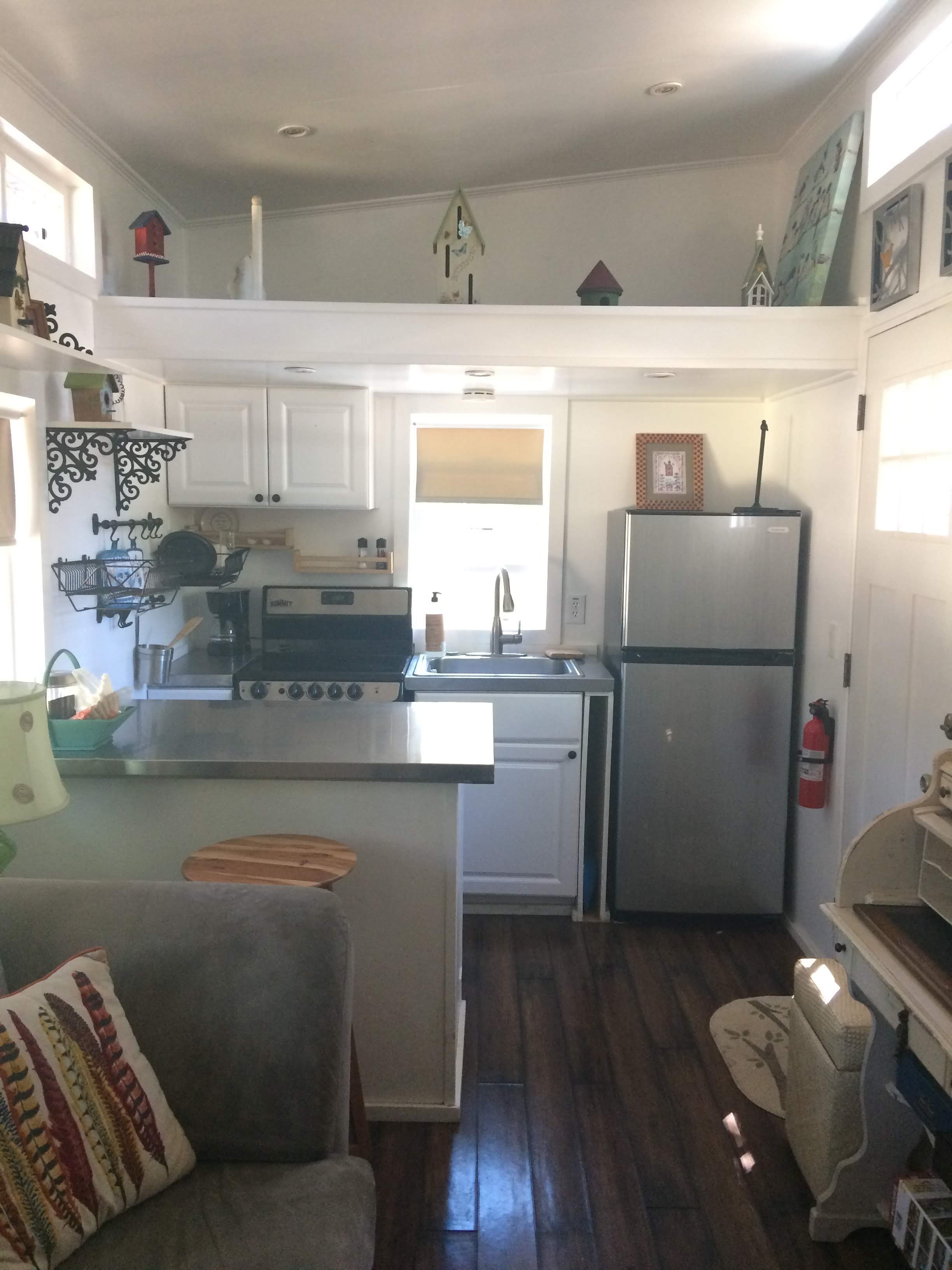 tiny travel chick tiny house block blue sky kitchen